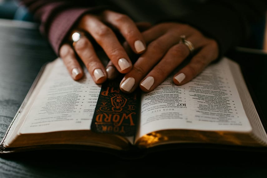 woman's hand on bible